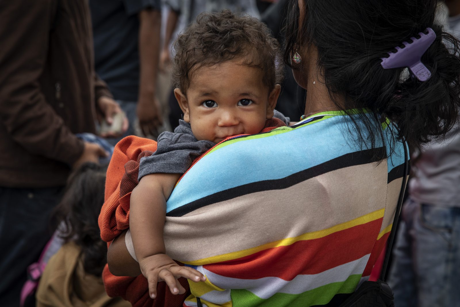 A mother with her child crosses the Simon Bolivar Bridge, one of 7 legal entry points on the Colombia-Venezuela border, the largest entry point with over 30,000 people crossing into Colombia on a daily basis.